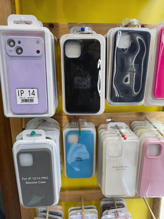 Silicone iPhone cases in various colours (lilac, black, blue, pink) on the display rack