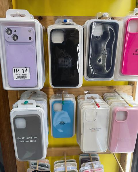 Silicone iPhone cases in various colours (lilac, black, blue, pink) on the display rack