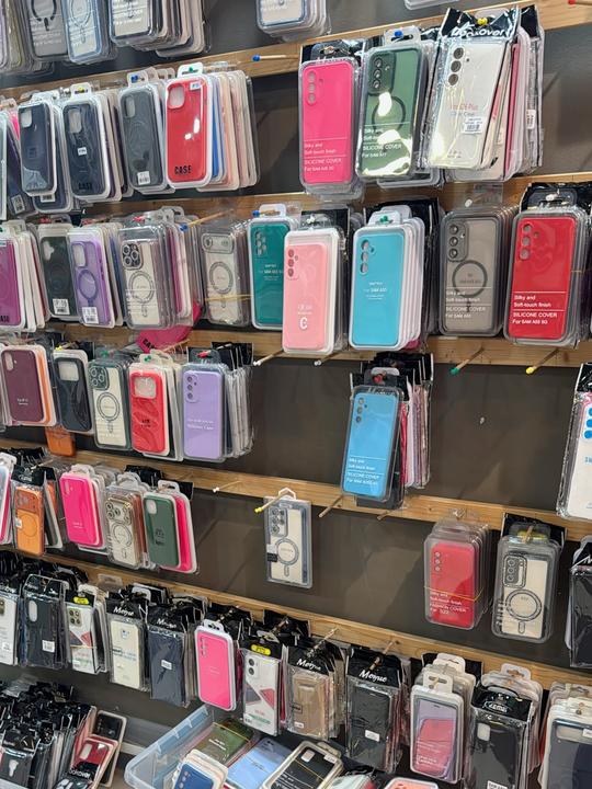 Shop wall lined with dozens of colourful smartphone cases